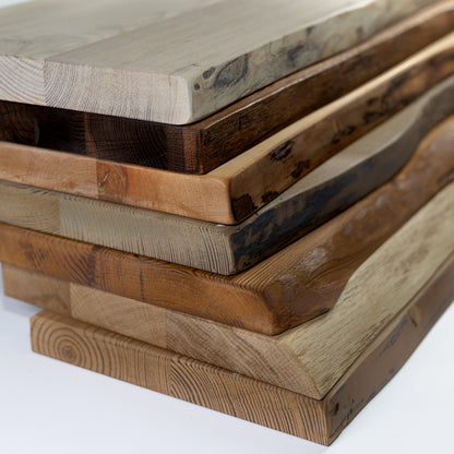 Stack of wooden shelves with various finishes on a white background